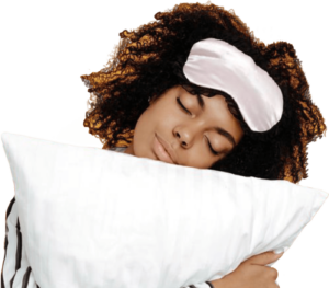 Woman leaning on pillow with sleep mask pulled up to her forehead